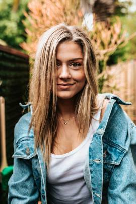 A blonde young woman smiling